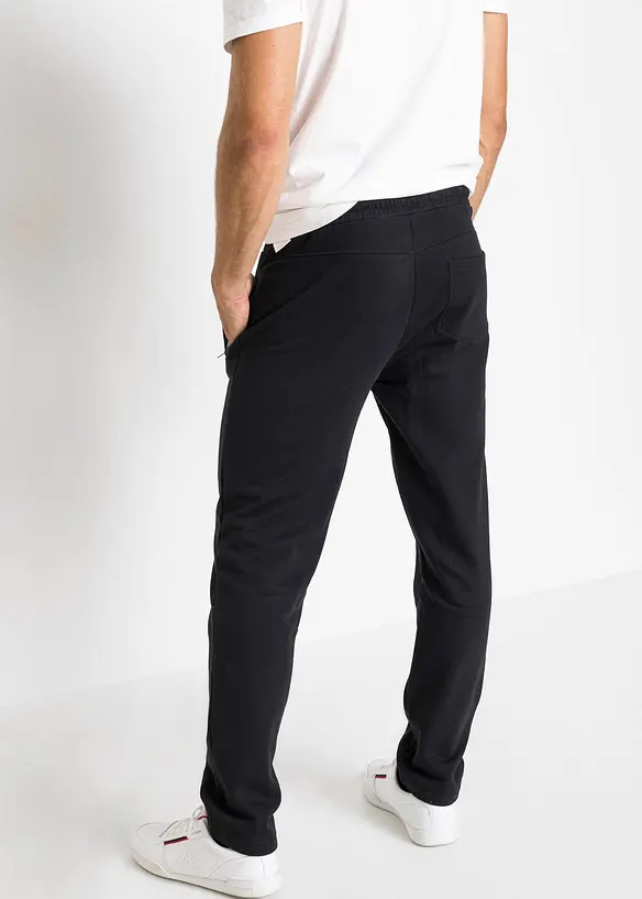 Jogginghose mit Reißverschlusstaschen in schwarz von hinten - bonprix